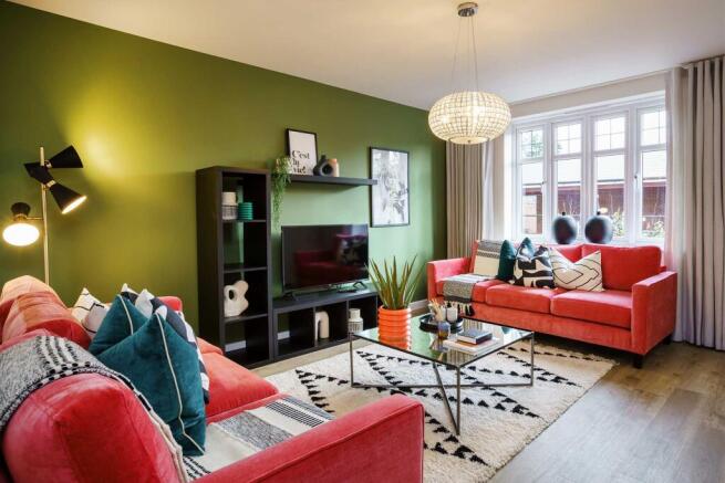 A cozy and vibrant living room with a red sofa, patterned rug