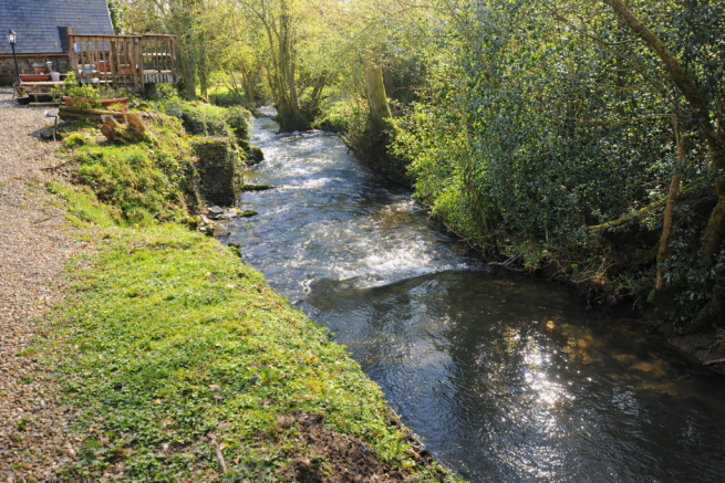 Brook running past Front of house and Raised deck
