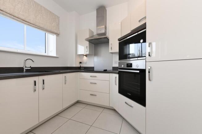 a kitchen with white cabinets