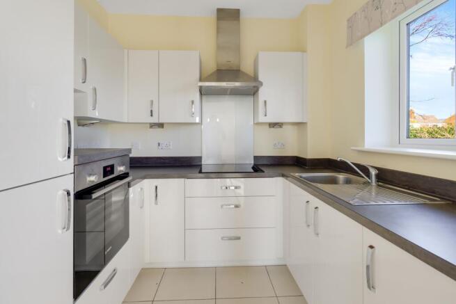 a kitchen with white cabinets