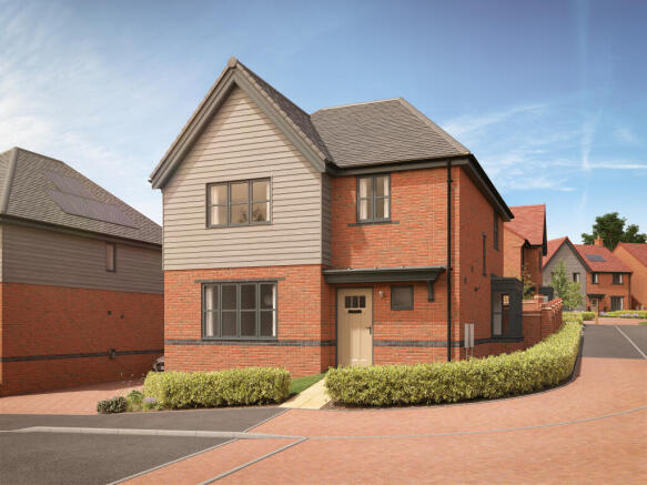 A modern brick house with a grey upper story sits behind a neatly trimmed hedge