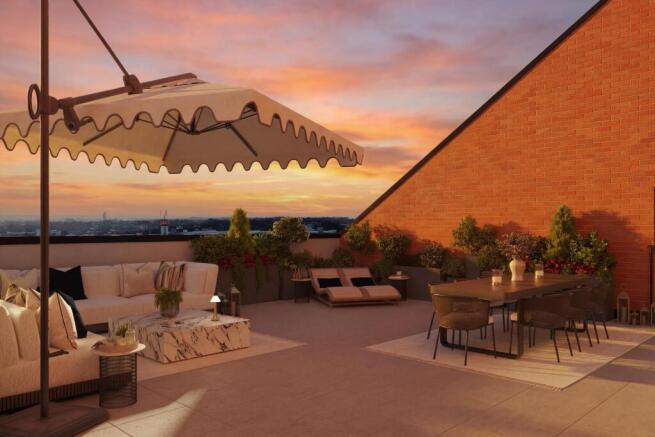 Dusk photo of a penthouse balcony with outdoor furniture, sun loungers and dining table
