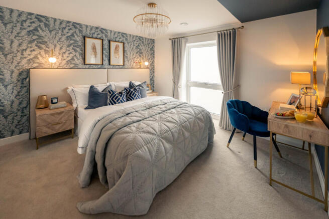 a bedroom with a bed and a desk