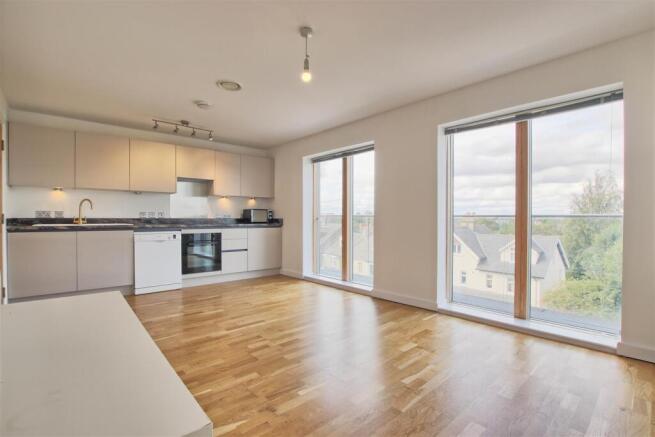 Living room showing kitchen door closed.jpg