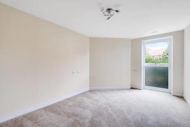 a room with a carpet and a ceiling fan