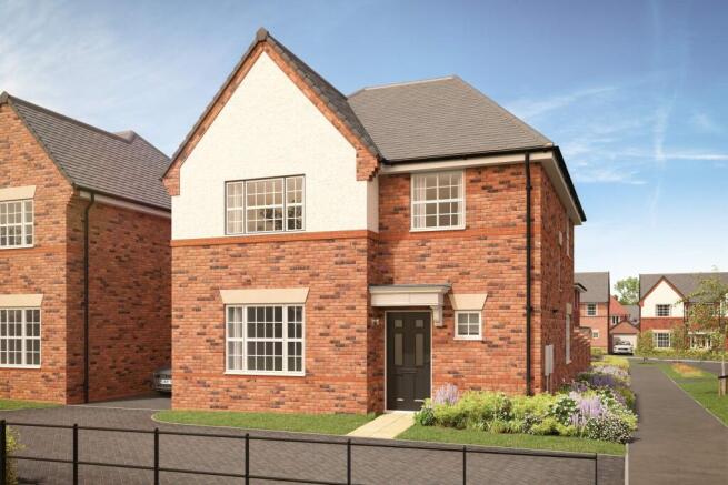 A modern brick house with a white gabled facade stands behind a black metal fence and a landscaped g