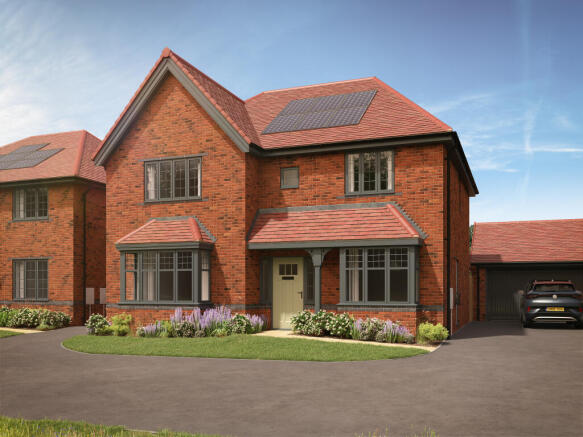 A modern brick house with solar panels on the roof sits in the foreground