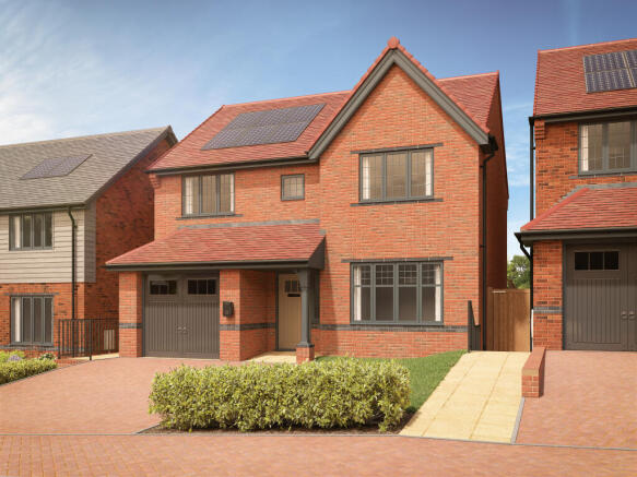 A modern brick house with solar panels on the roof sits behind a neatly trimmed hedge