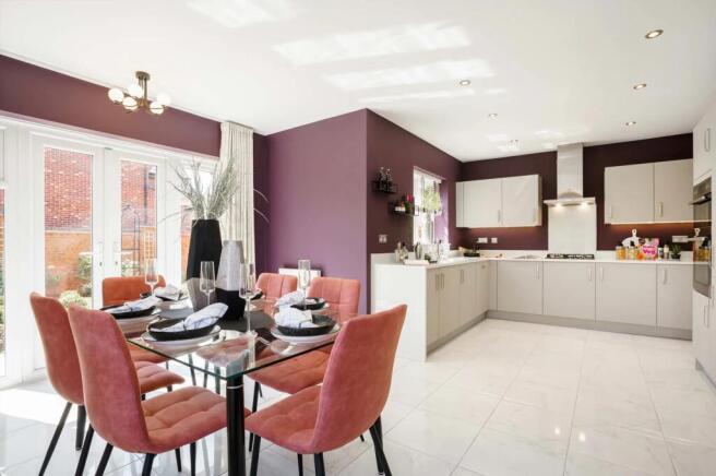 A modern and stylish kitchen and dining area with a glass-topped table surrounded by plush pink chai