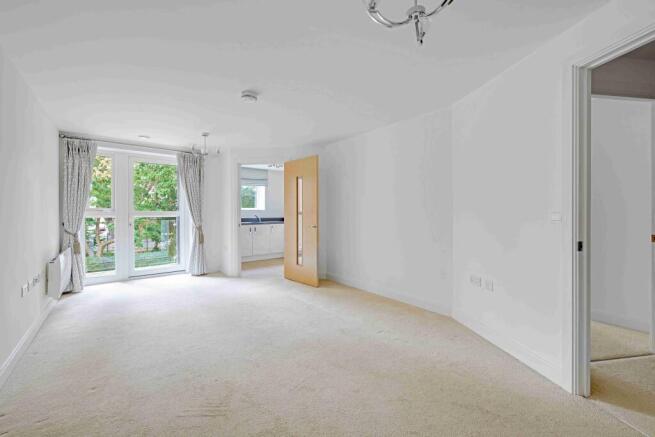 a room with a carpet and windows