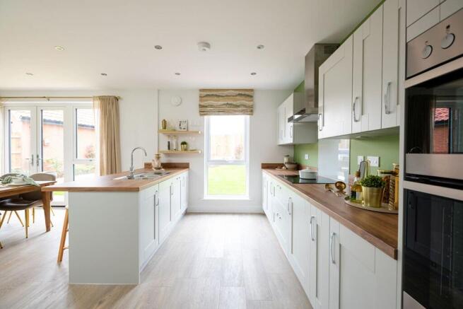 The modern kitchen is light and has ample storage and worktop space
