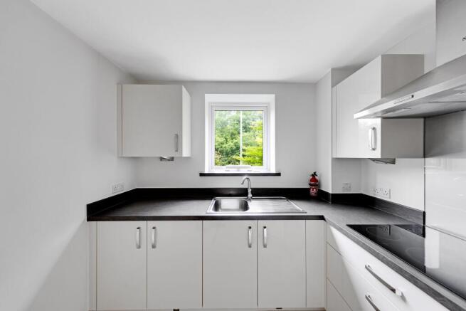 a kitchen with white cabinets