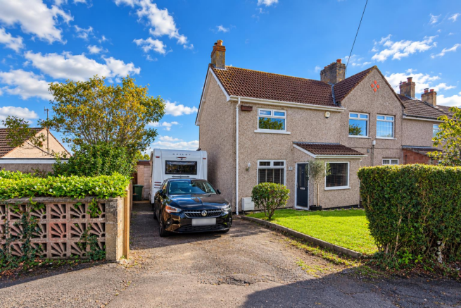 Sunny Suburban Home with Caravan.png
