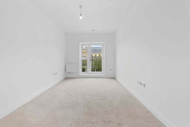 a room with a window and a carpet