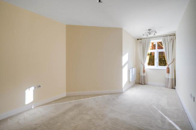 a room with a carpet and curtains