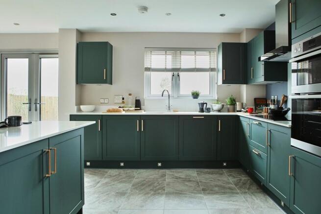 The modern kitchen provides ample storage and worktop space