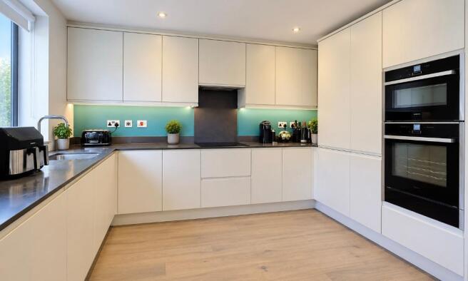 Kitchen with fitted appliances