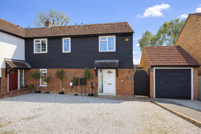 Charming semi-detached house in sunlight.png