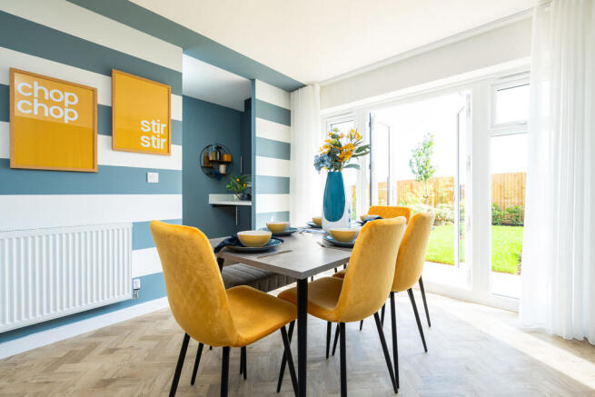 A modern and vibrant dining area with a wooden table, yellow upholstered chairs
