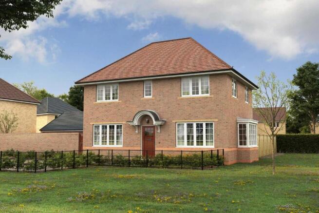 A two-story brick house with a red tile roof sits on a grassy lawn surrounded by trees