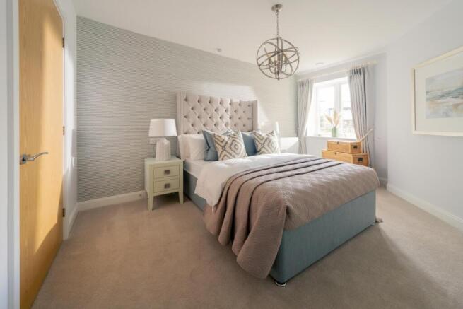 a bedroom with a bed and a lamp