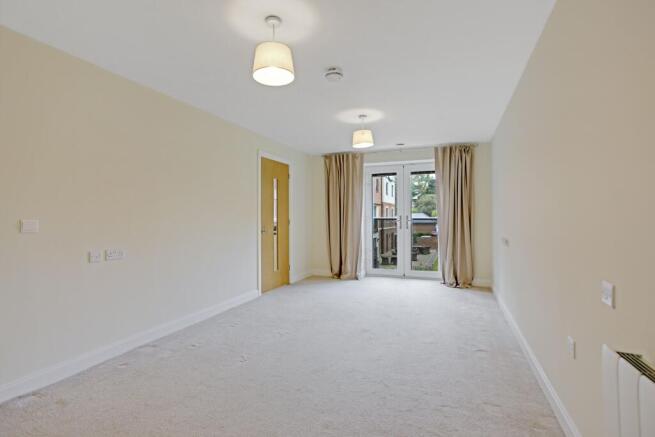 a room with a carpet and a door with a window