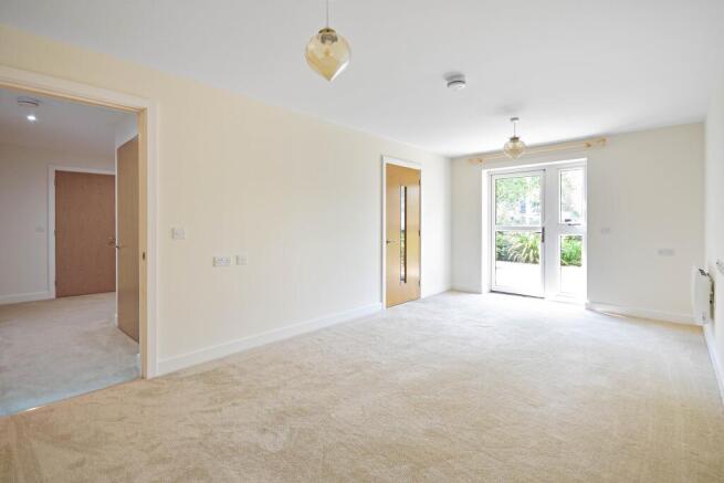 a large empty room with a carpet