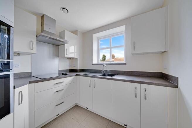 a kitchen with white cabinets