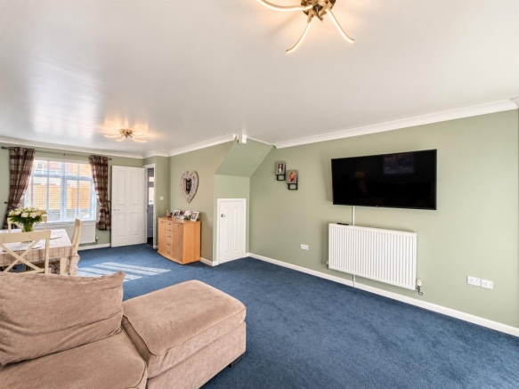 Sage Green Living Room with Blue Carpet.png