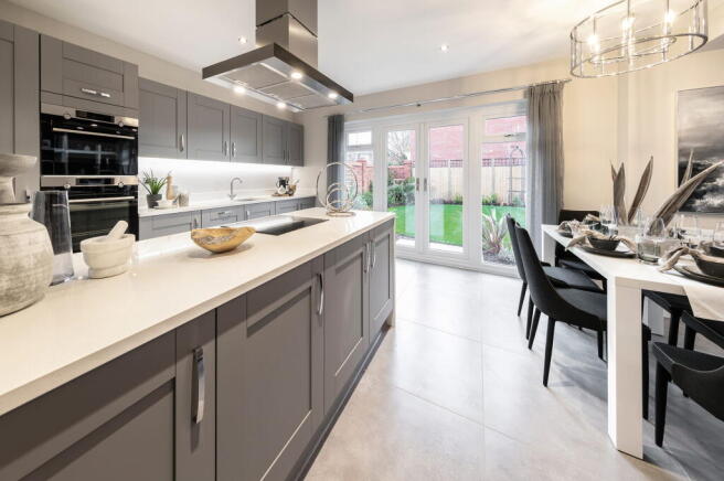A modern, well-designed kitchen with gray cabinets, a white countertop