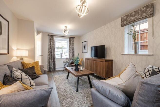 photo of a lounge with two grey sofas and a rug