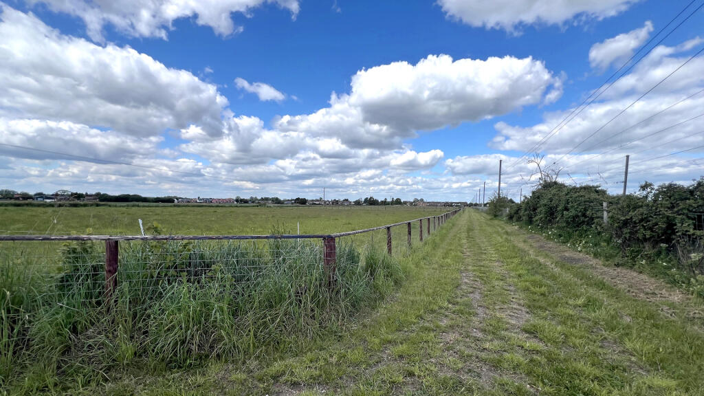 Fully enclosed by post and rail fencing.
