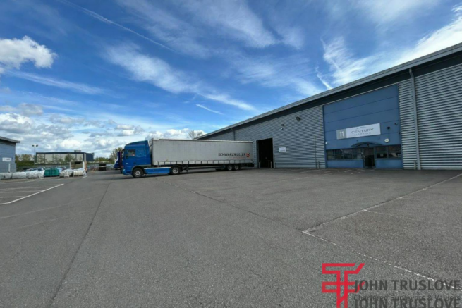Industrial warehouse with parked truck.png