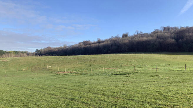 Land for sale in Tring with well-defined fenced boundaries.
