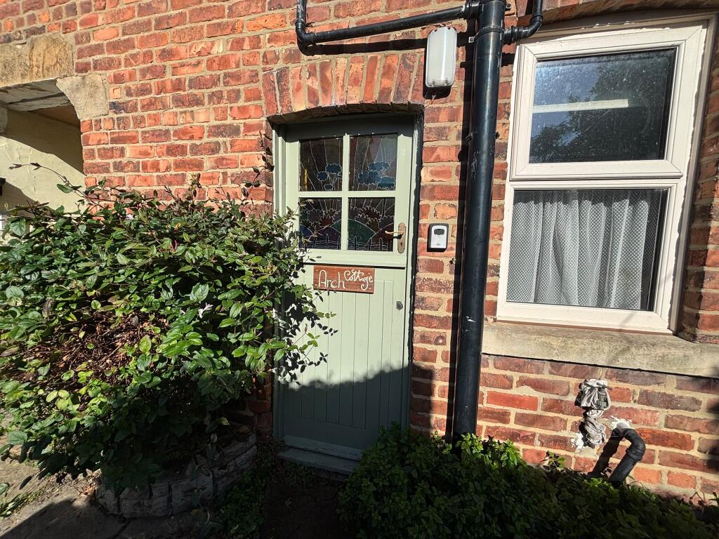 Main image of property: Arch Cottage, High Street, Ruswarp, Whitby, North Yorkshire YO21 1NH