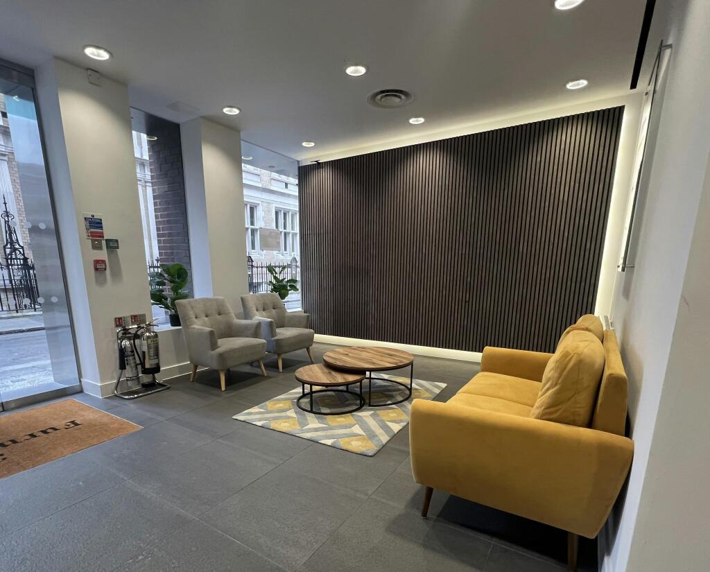 30-31 Furnival  Modern Lobby With Seating And Decorative Wall Panel.jpg