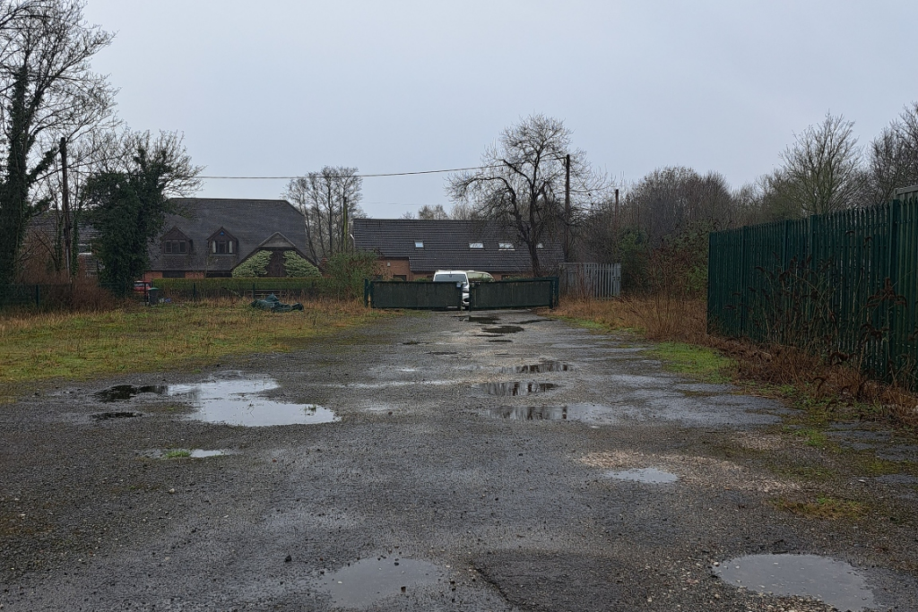 A large plot of land, with fencing around it.