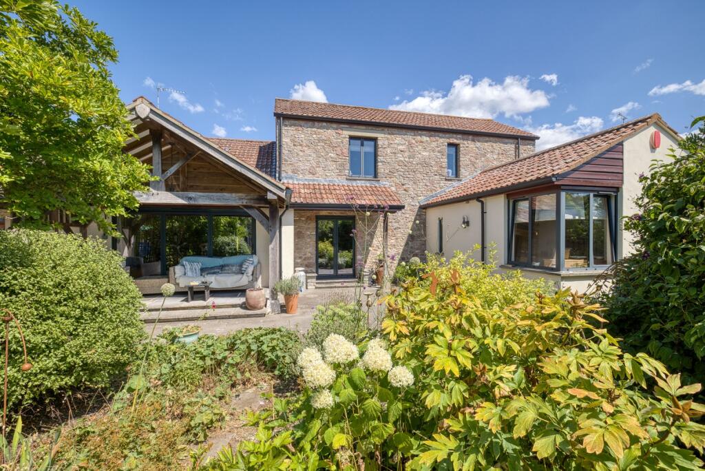 Main image of property: A hidden gem - period barn conversion with secluded gardens and orchard